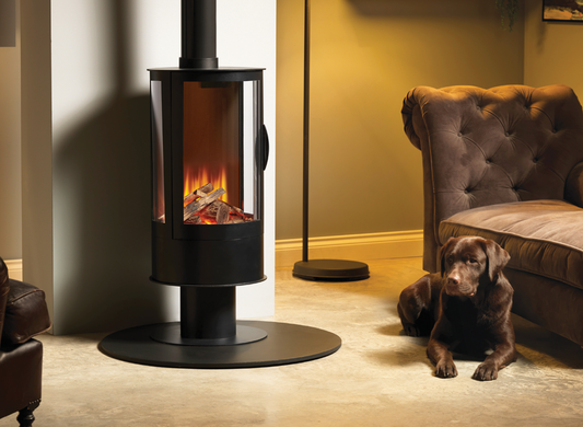 Modern electric stove in a livingroom setting with brown sofa and brown lab